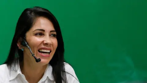 Reuters Presidential candidate Luisa Gonzalez speaks to a local radio station after coming top in a first round of voting for Ecuador's presidency, in Quito, Ecuador August 21, 2023.