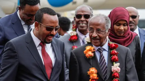 AFP Ethiopia's Prime Minister Abiy Ahmed (L) walks with Eritrea's Foreign minister Osman Saleh Mohammed (R) as Eritrea's delegation arrives for peace talks with Ethiopia at the international airport in Addis Ababa, Ethiopia, on June 26, 2018.