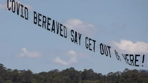 38 Degrees Airborne banner reading "Covid bereaved say get out of here!"