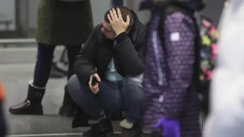 EPA A relative of the crash of Ukraine International Airlines Flight PS752 from Tehran reacts, at Boryspil International Airport in Kiev, Ukraine