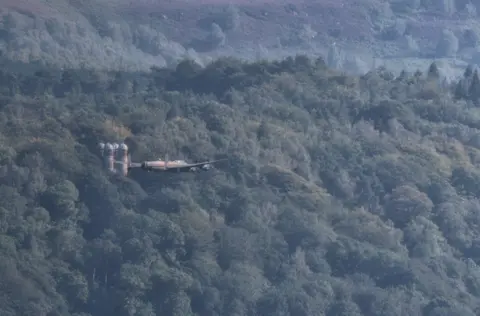 Villager Jim Lancaster Bomber flying past the hunting tower at Chatsworth House, in Derbyshire