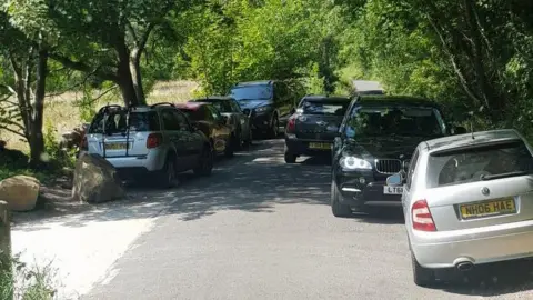 Hulleys of Baslow Cars blocking bus passing