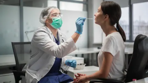 Getty Images Patient being swabbed