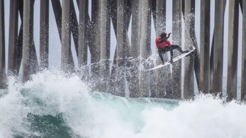 Getty Images Cherif Fall surfing during the A Great Day in the Stoke event in California, the US - Saturday 4 June 2022