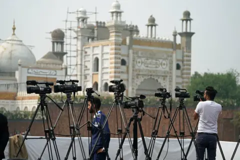 Owen Humphreys/PA Wire Media await the royal couple at the National Cricket Academy