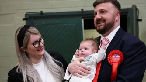 PA Media Chris Webb with wife Portia and new born Cillian