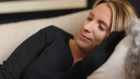 Kate on the couch in pain