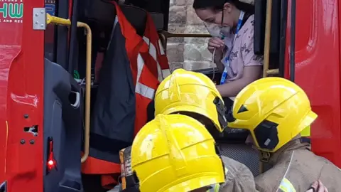 Hereford & Worcester Fire and Rescue Service A "patient" is helped out by crews