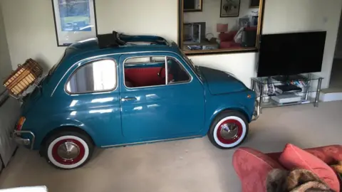 Exclusive Motor Company Teal Fiat 500 in the living room