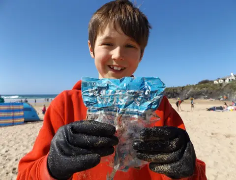 Beach Guardian Beach Guardian volunteer Laurence Miller with his crisp packet