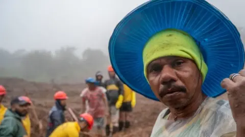 49 years old Ram Gomavir searching their sister and her family, rescue operations are going on where people trapped under rubble after landslide in Khalapur Irshalwadi Village on July 20, 2023 in Raigad, India.