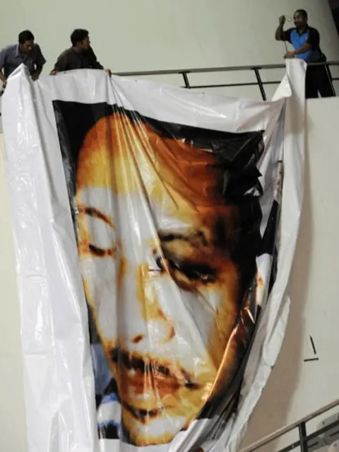 ROSLAN RAHMAN/AFP/Getty Images Supporters of Malaysian opposition leader Anwar Ibrahim hang a poster of him at a rally in Selangor state on July 1, 2008 showing a black eye inflicted in a severe beating by the police chief shortly after his sacking