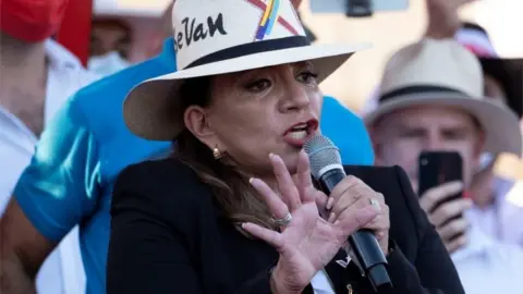 EPA Honduran presidential candidate Xiomara Castro, from the Libertad y Refundacion (Libre) party and wife of the country's former president Manuel Zelaya, speaks during the closing of her campaign in the city of San Pedro Sula, Honduras, 20 November 2021