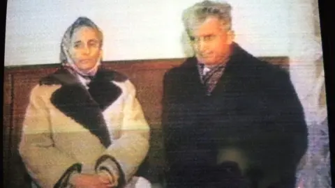 Getty Images Elena and Nicolae Ceausescu during their summary trial (TV grab taken on 25 December 1989)