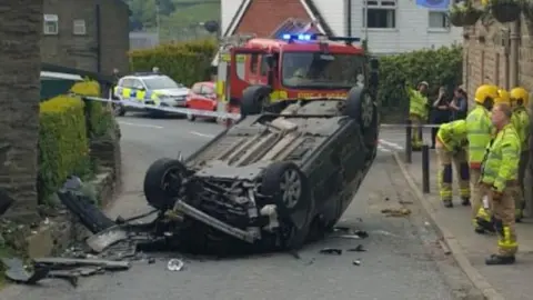 Car flipped on to its roof on Tong End in Whitworth