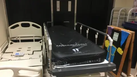 Bed and trolley on a landing