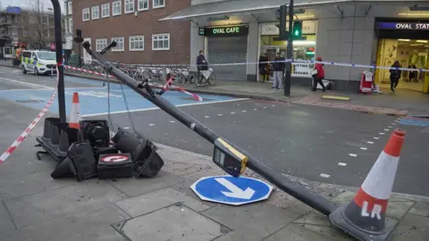 PA Media Knocked down traffic light post outside Oval station