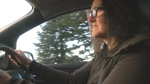 Marie Neal driving an electric powered car