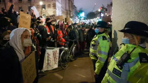 Reuters Protesters face police officers who stand in front of the Winston Churchill statue in Parliament Square