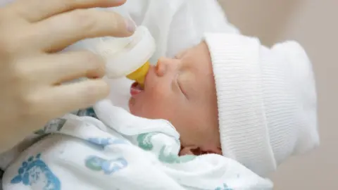 Getty Images Bottle feeding a newborn baby