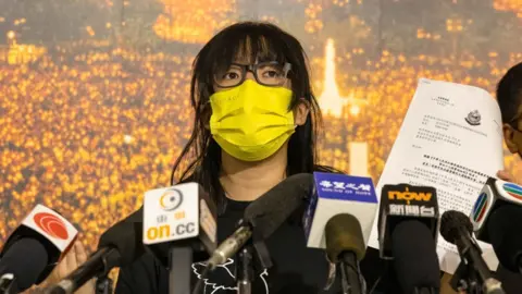 Getty Images Chow Hang Tung speaking a press conference following national security law charges in September 2021