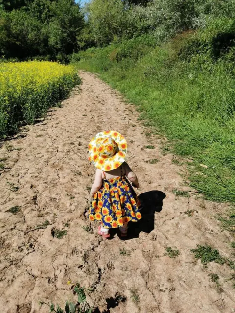 Louise Amos Girl walking on a path