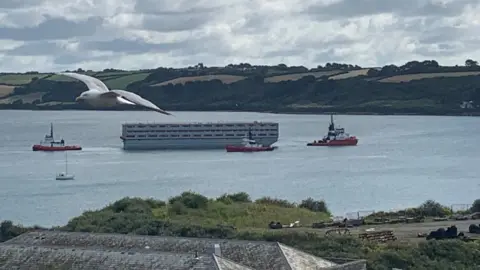 BBC Bibby Stockholm being towed out of Falmouth