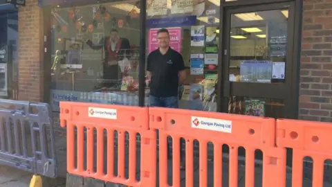 Lee Roberts outside his shop