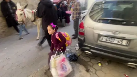 Mohammed Ghalayini Mohammed Ghalayini's niece carries bags of luggage