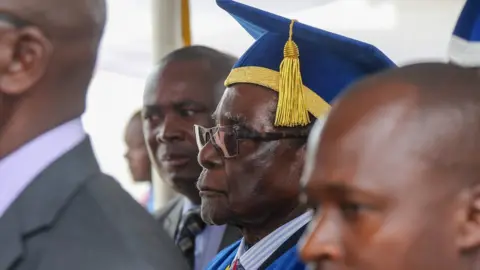Getty Images Robert Mugabe attends a graduation at a university in Harare not long before he resigned as Zimbabwe's president in November 2018