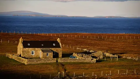Jeff J Mitchell/ Getty Images Picture of solitary house on the island of Foula.