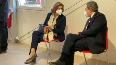 Reuters Mario Draghi and his wife Maria Serenella Cappello speak in a waiting room after receiving their first doses of the AstraZeneca jab