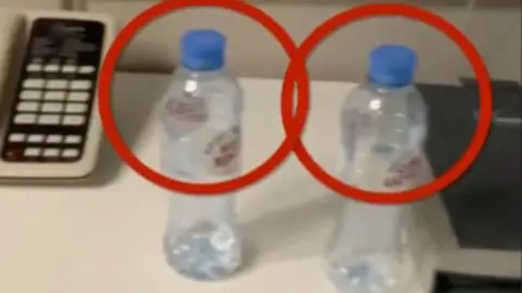 Reuters Two empty water bottles are circled in red