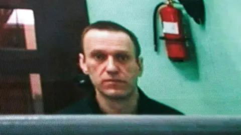 Russian opposition figure Alexei Navalny is seen on a screen via a video link from his penal colony during a hearing about his right to correspond while in jail, at the Russian Supreme court in Moscow, Russia, 22 June 2023