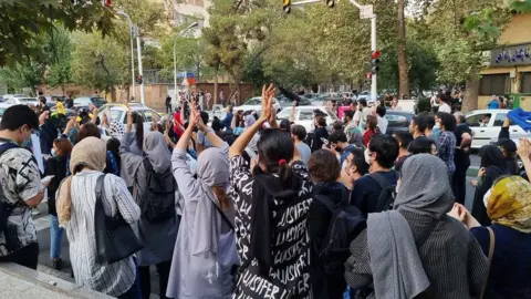 Getty Images People gather in protest against the death of Mahsa Amini along the streets on September 19, 2022 in Tehran, Iran