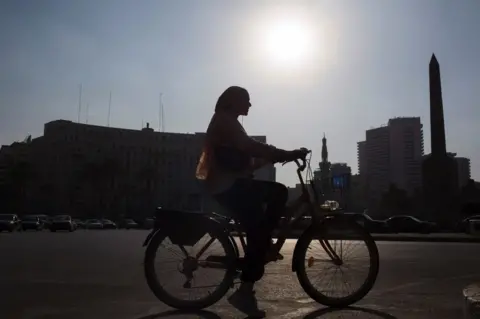 Reuters A woman rides a bike via "Cairo Bike", a project about using bikes around the capital to encourage the preservation of the environment, in Egypt November 18, 2022