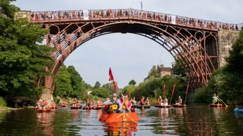 Getty Images A flotilla of boats accompanied the baton down the River Severn at Ironbridge