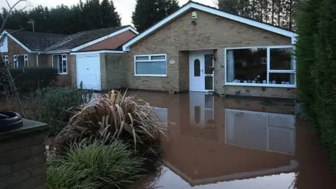 LINDSEY PARNABY Flood water around a house in Lowdham