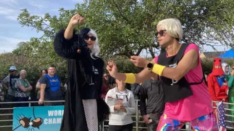 Nadia Gyane/BBC People playing conkers