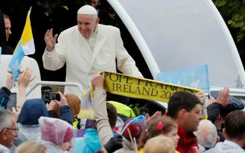 Reuters Pope Francis waves to the crowd as he travels in the popemobile to the Knock shrine