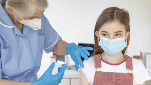 young girl getting a jab