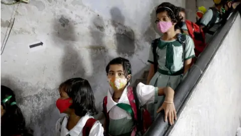 EPA Students wait to receive the Covid-19 vaccine Corbevax manufactured by Biological E. Limited during a vaccination drive at a government school in Kolkata, Eastern India, 21 March 2022