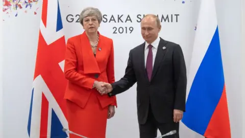 Getty Images Theresa May shaking hands with Vladimir Putin