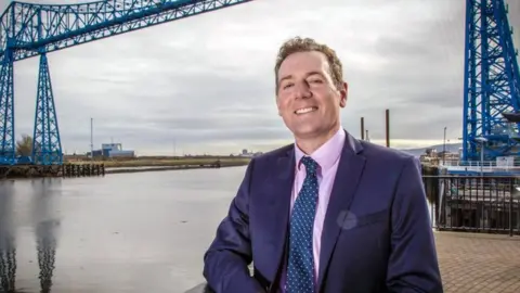 BBC Andy Preston next to the Tees Transporter Bridge