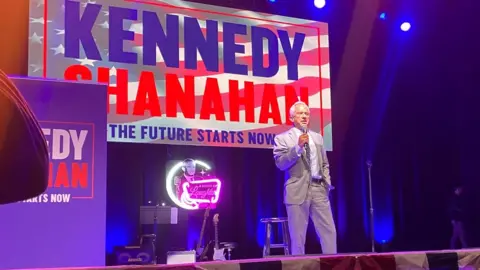 BBC Mr Kennedy on stage at a fundraising event