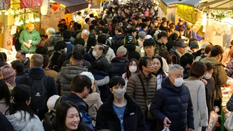 EPA-EFE/REX/Shutterstock Shoppers in Tokyo, Japan.