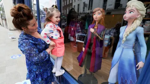 PA Media A mother and daughter at window of Disney Store in Dublin, 7 Jun 20