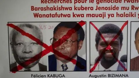 AFP A red cross is seen drawn on the face of Augustin Bizimana (R), one of the most-wanted fugitives from the 1994 Rwandan genocide, next to the red-crossed face of Felicien Kabuga