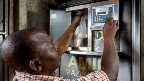 Jeroen van Loon Jackson Opati with the Zaidi Technologies milk ATM in his shop in Kibera, Nairobi
