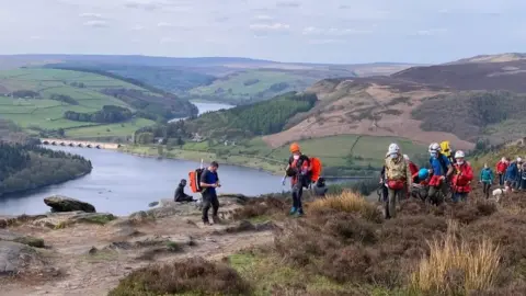 Edale Mountain Rescue Team  Injured climber carried away on stretcher